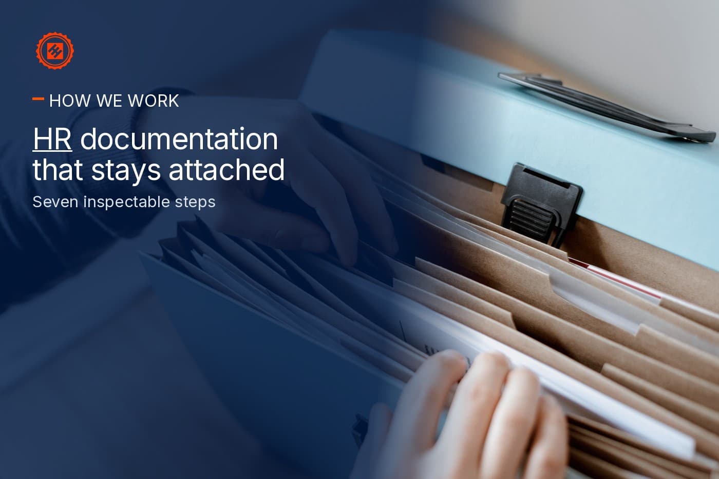 Hands reviewing a working file at a desk — HR that stays attached after arrival.