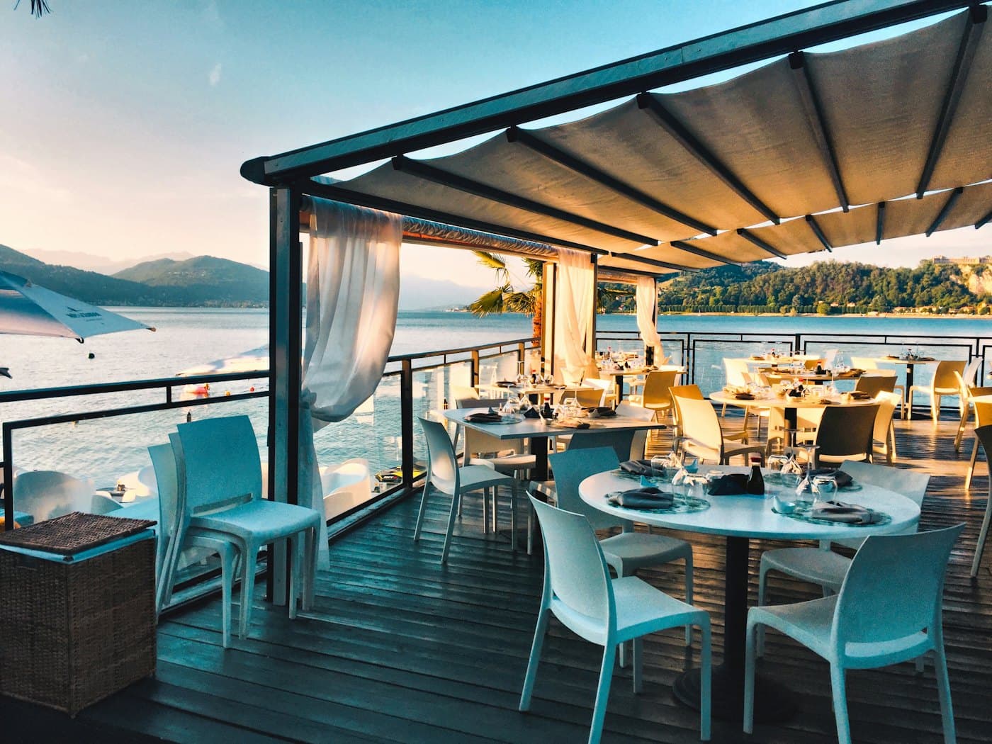 A prepared hospitality terrace at dusk — kitchen, service, and property roles ISHC recruits for.