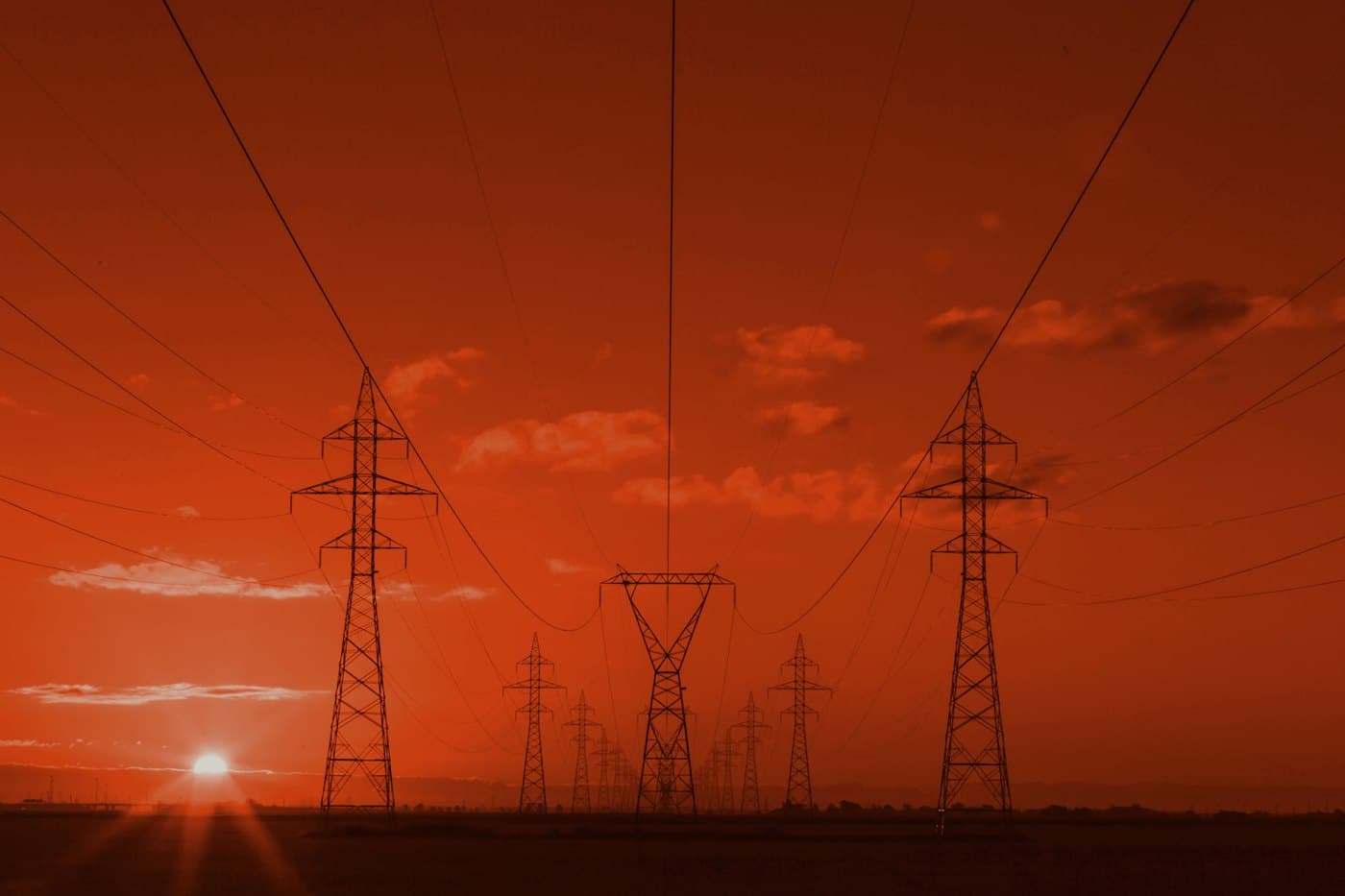 Power lines at dusk — site electrics, not a licence claim.